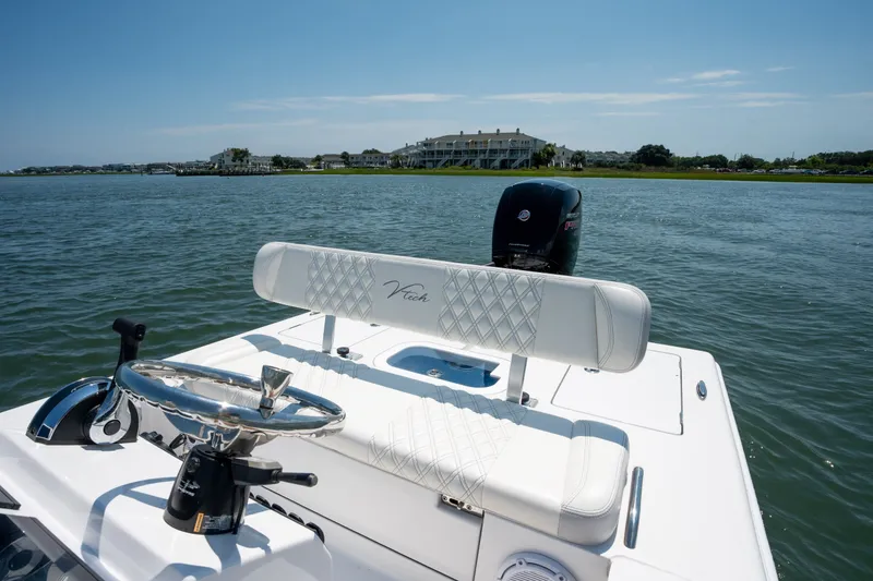 Slide: The Image of Vtech 18 FLATS 2021 boat on water, featuring steering wheel and cushioned seating. - 13