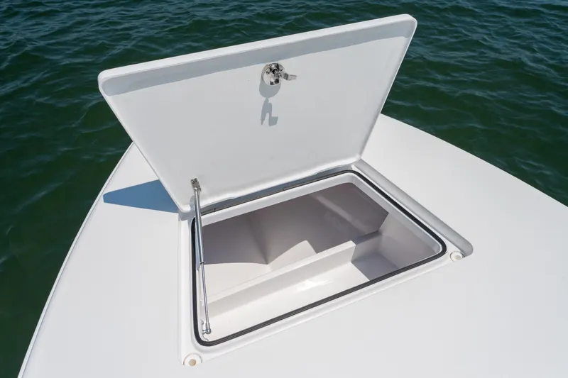 Slide: The Image of Open storage compartment on 2021 Vtech 18 FLATS boat, floating on water. - 19