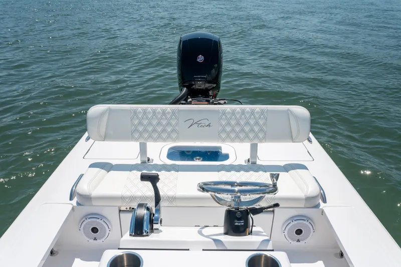 Slide: The Image of 2021 Vtech 18 FLATS boat interior with steering wheel and seating on open water. - 14