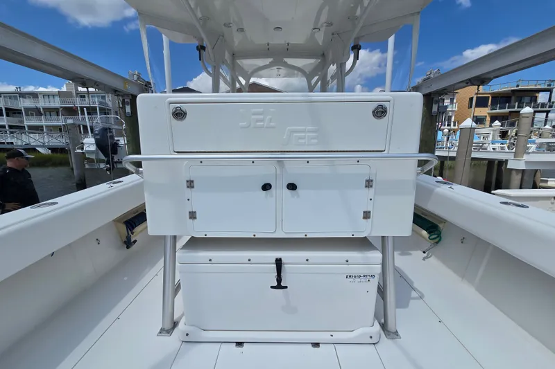Slide: The Image of 2006 SeaVee 340B boat interior with storage compartments, docked at a marina under a clear sky. - 28