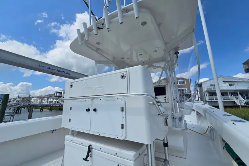 Slide: The Image of 2006 SeaVee 340B boat interior with console, docked under a clear blue sky. - 17