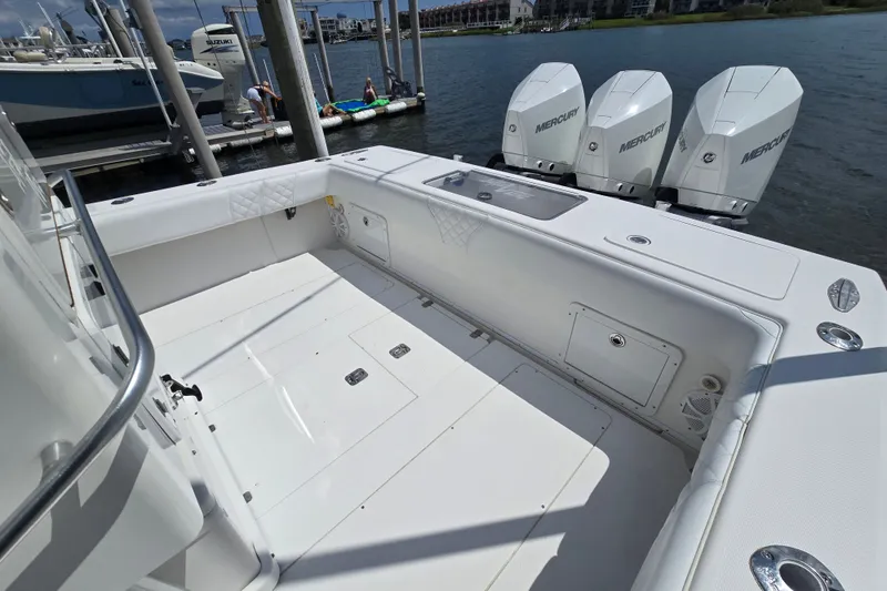 Slide: The Image of 2006 SeaVee 340B boat with triple Mercury engines docked by the water. - 24
