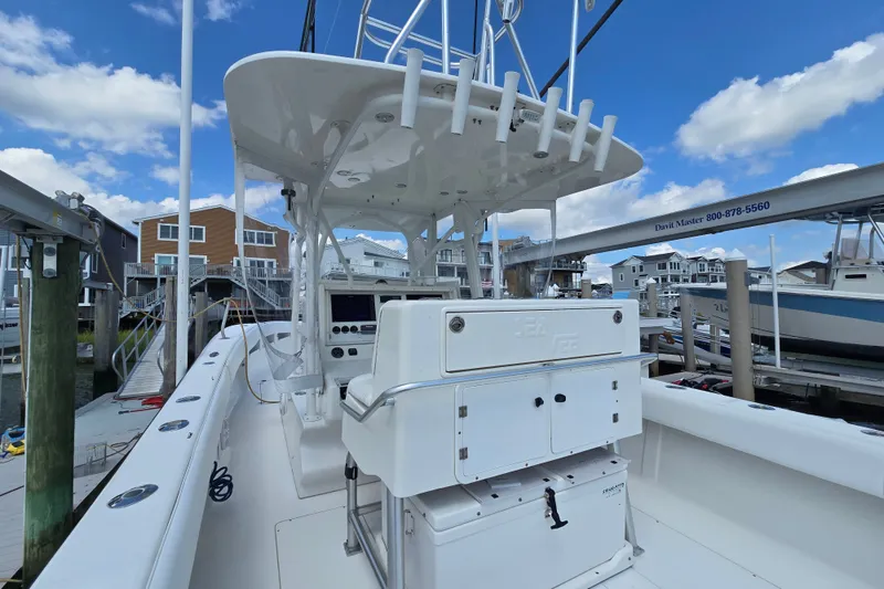 Slide: The Image of 2006 SeaVee 340B boat docked, featuring a spacious helm and fishing rod holders. - 16