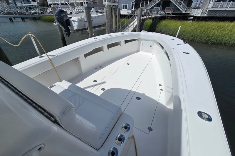 Slide: The Image of 2006 SeaVee 340B boat with spacious deck, docked near waterfront homes. - 18