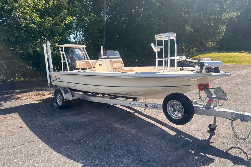 Slide: The Image of 2022 Ocean Scout Sport 177 boat on trailer, parked outdoors in sunny setting. - 18
