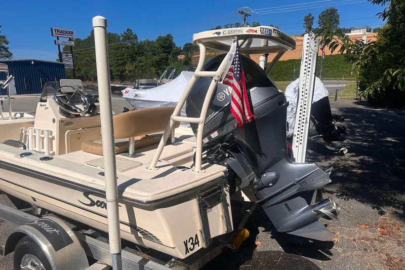 Slide: The Image of 2022 Ocean Scout Sport 177 boat with Yamaha motor and American flag, parked outdoors. - 14