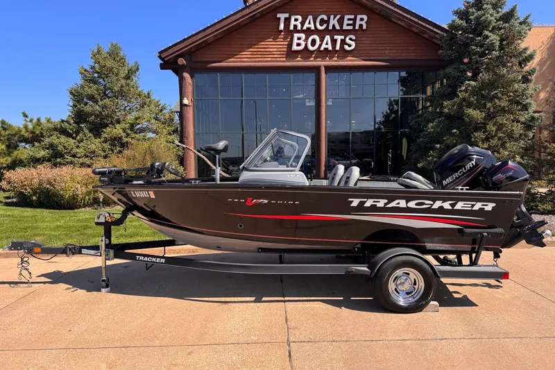 The Image of 2017 Tracker Pro Guide V-17 WT boat on trailer outside Tracker Boats showroom. - 0