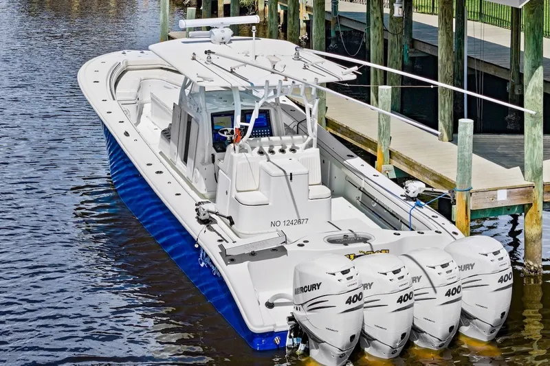 Slide: The Image of 2013 Yellowfin 39 Offshore boat docked, featuring four Mercury 400 engines. - 5