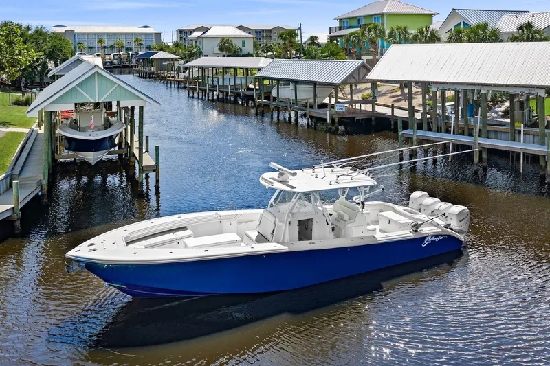 Slide: The Image of 2013 Yellowfin 39 Offshore boat docked in a scenic marina setting. - 4