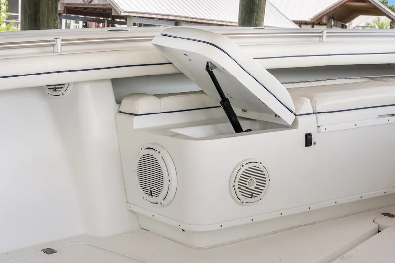 Slide: The Image of 2013 Yellowfin 39 Offshore boat interior with open storage compartment and speaker. - 59