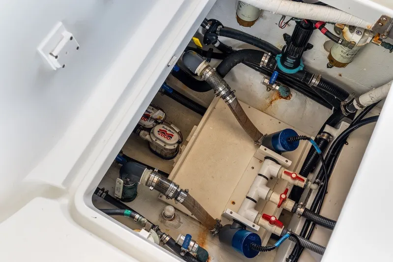 Slide: The Image of 2013 Yellowfin 39 Offshore boat plumbing system with hoses and valves. - 65