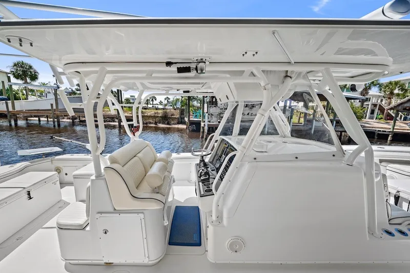 Slide: The Image of 2013 Yellowfin 39 Offshore boat interior with helm, seating, and waterfront view. - 22