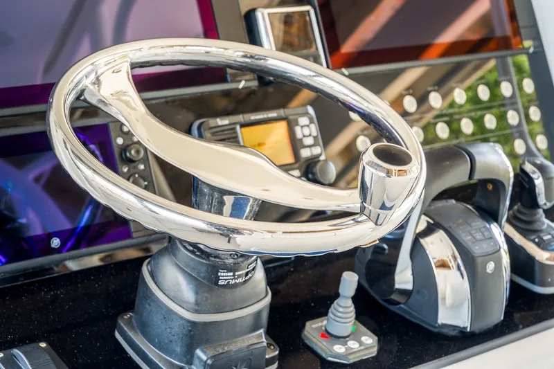 Slide: The Image of Steering wheel and controls of a 2013 Yellowfin 39 Offshore boat cockpit. - 56