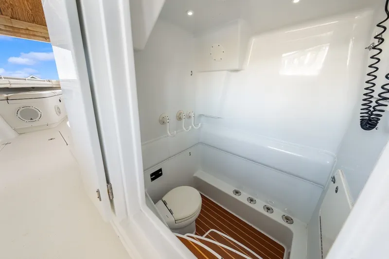 Slide: The Image of Interior of 2013 Yellowfin 39 Offshore boat, featuring a compact marine bathroom. - 67