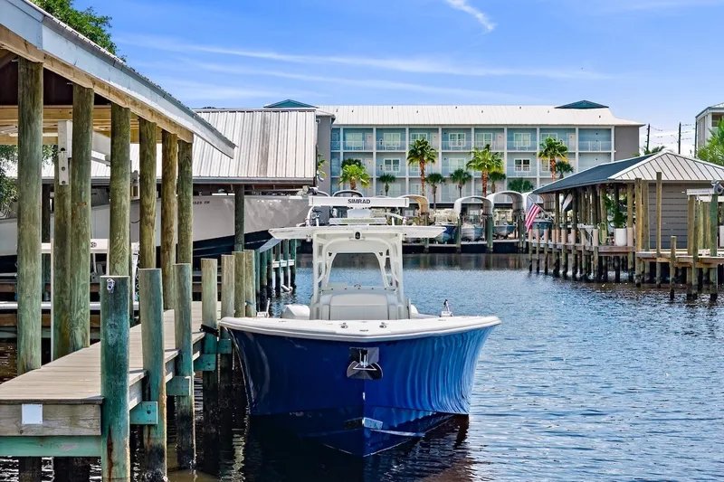Slide: The Image of 2013 Yellowfin 39 Offshore boat docked in a marina with blue skies. - 20