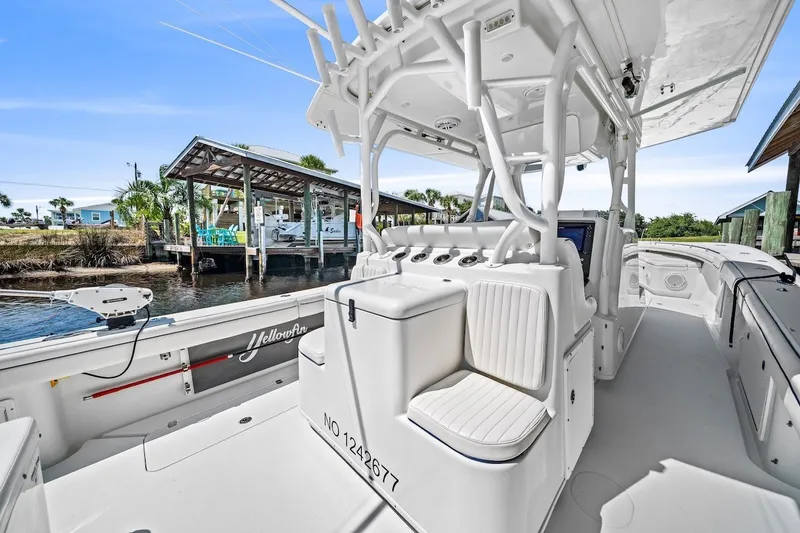Slide: The Image of 2013 Yellowfin 39 Offshore boat interior with helm station and seating, dockside view. - 33
