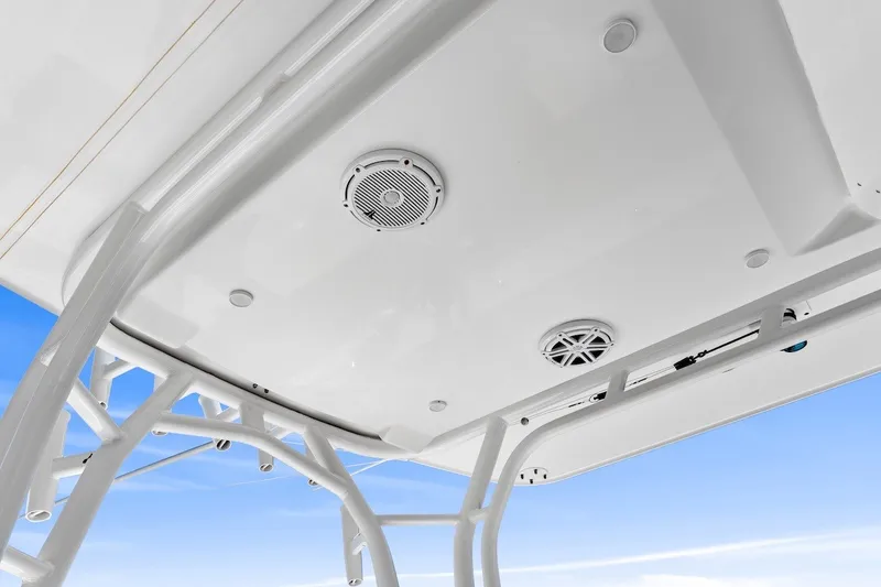 Slide: The Image of 2013 Yellowfin 39 Offshore boat ceiling with speakers against blue sky. - 23