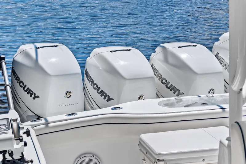 Slide: The Image of Four Mercury outboard engines on a 2013 Yellowfin 39 Offshore boat, docked on water. - 43