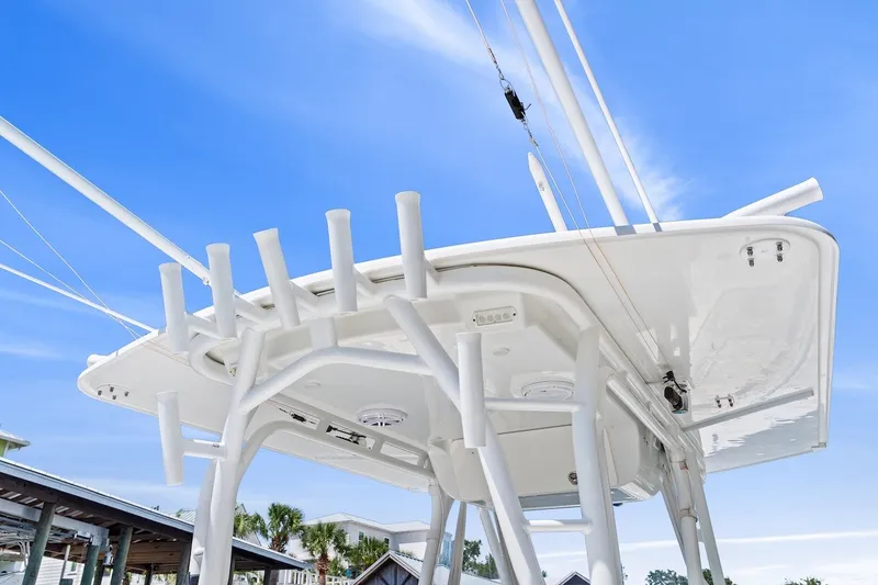 Slide: The Image of 2013 Yellowfin 39 Offshore boat with white T-top against a clear blue sky. - 29