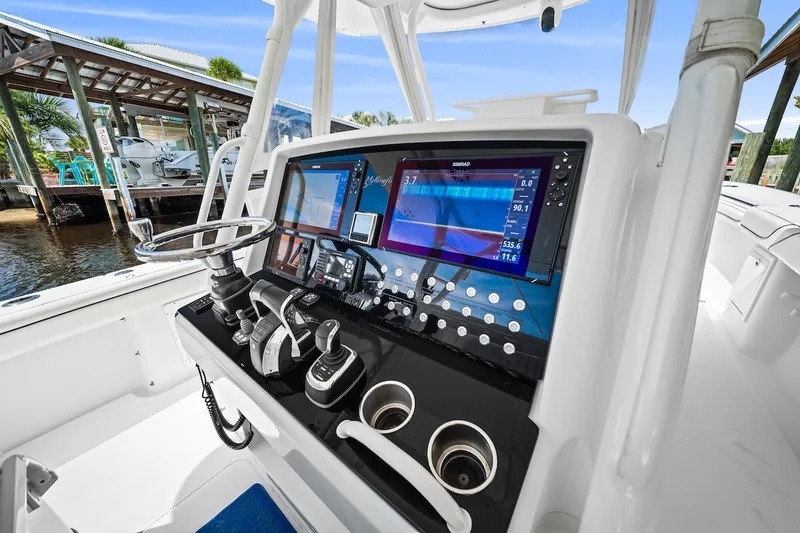 Slide: The Image of 2013 Yellowfin 39 Offshore boat dashboard with advanced navigation and control systems. - 48