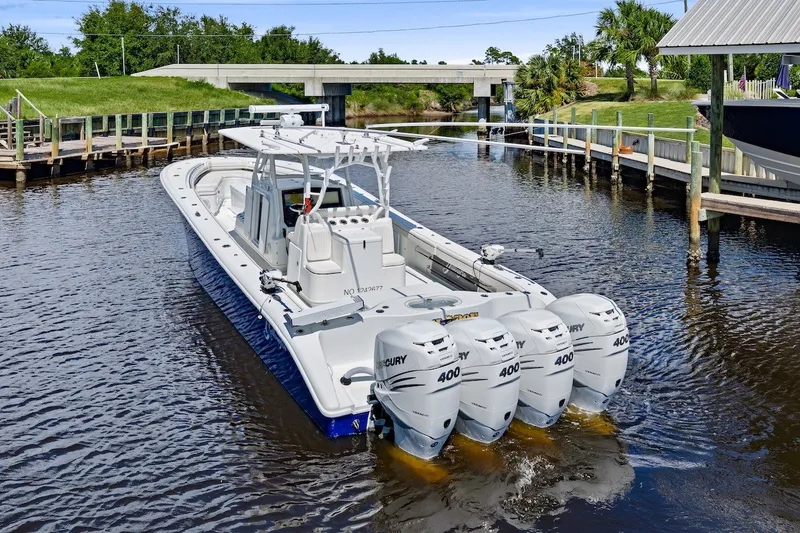 Slide: The Image of 2013 Yellowfin 39 Offshore boat with four Mercury 400 engines on a calm waterway. - 10