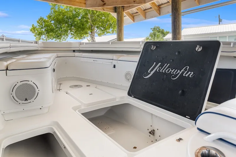 Slide: The Image of 2013 Yellowfin 39 Offshore boat interior with open storage compartment under wooden canopy. - 58