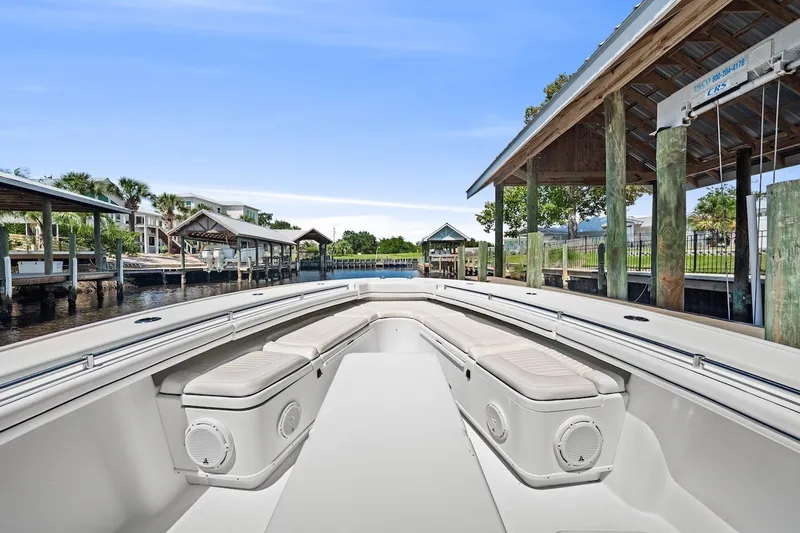 Slide: The Image of 2013 Yellowfin 39 Offshore boat docked, featuring spacious seating and sleek design. - 21