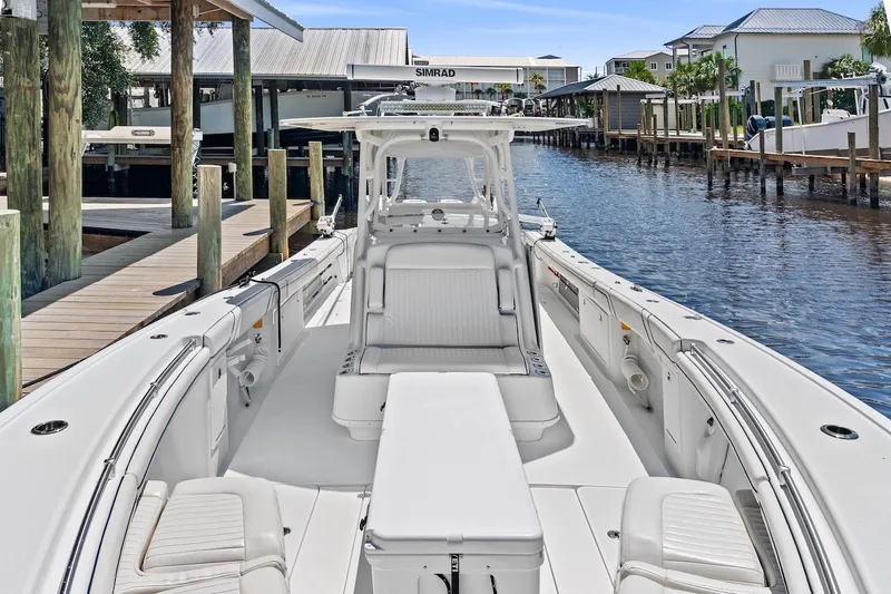 Slide: The Image of 2013 Yellowfin 39 Offshore boat docked, featuring spacious seating and sleek design. - 27