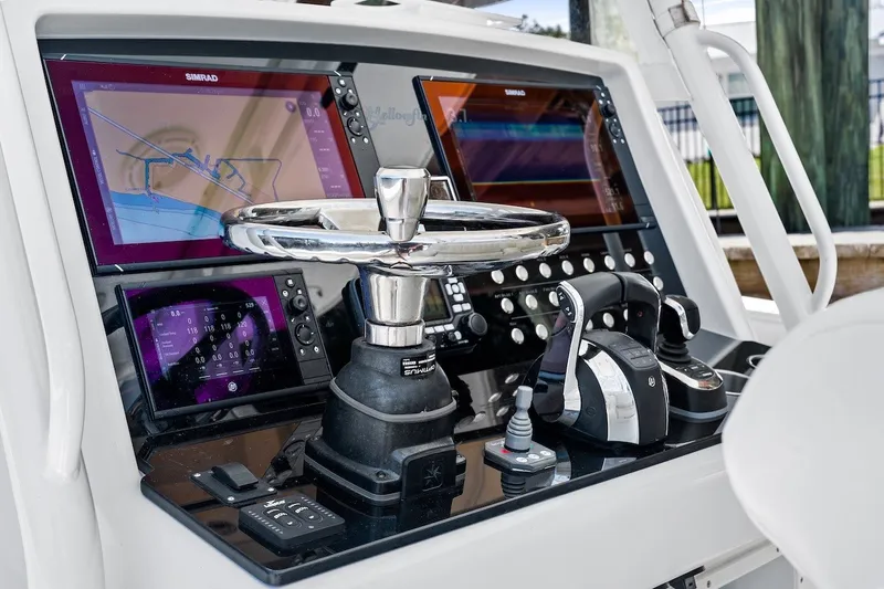Slide: The Image of Control panel of a 2013 Yellowfin 39 Offshore boat with advanced navigation systems. - 52