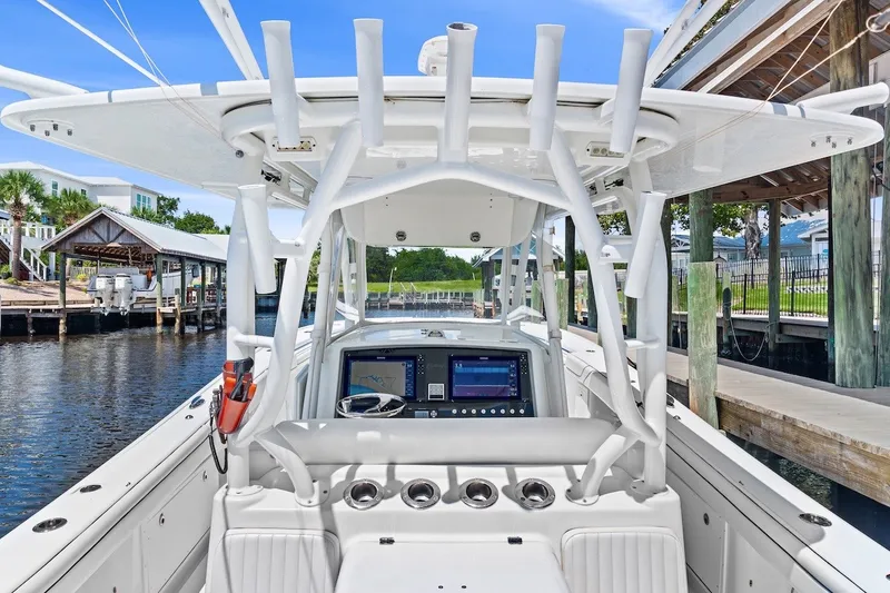 Slide: The Image of 2013 Yellowfin 39 Offshore boat interior with advanced navigation system at a marina. - 53
