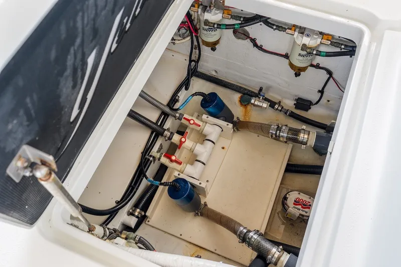 Slide: The Image of Engine compartment of a 2013 Yellowfin 39 Offshore boat, showcasing fuel filters and hoses. - 64