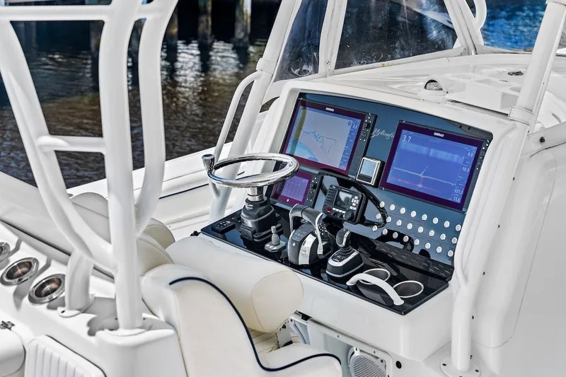 Slide: The Image of 2013 Yellowfin 39 Offshore boat cockpit with advanced navigation and control systems. - 50