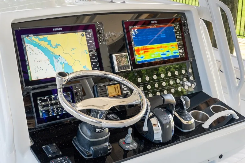 Slide: The Image of 2013 Yellowfin 39 Offshore boat dashboard with navigation screens and controls. - 61