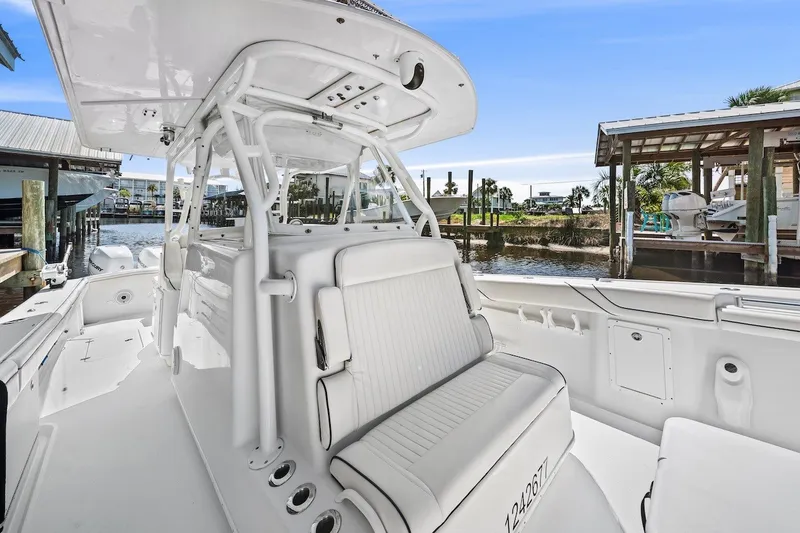 Slide: The Image of 2013 Yellowfin 39 Offshore boat interior, featuring sleek white seating and helm station. - 31