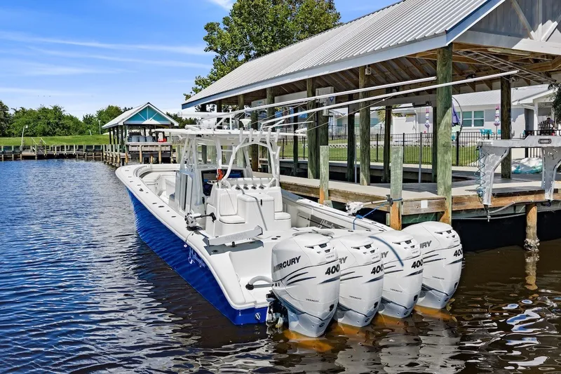 Slide: The Image of 2013 Yellowfin 39 Offshore boat docked with four Mercury 400 engines. - 12