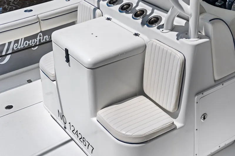 Slide: The Image of 2013 Yellowfin 39 Offshore boat interior with cushioned seating and storage compartment. - 40
