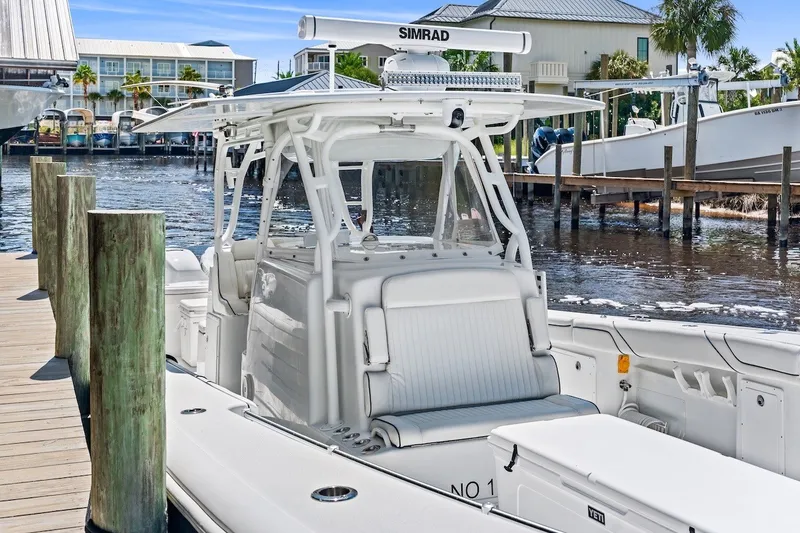 Slide: The Image of 2013 Yellowfin 39 Offshore boat docked at marina, featuring sleek design and advanced equipment. - 46