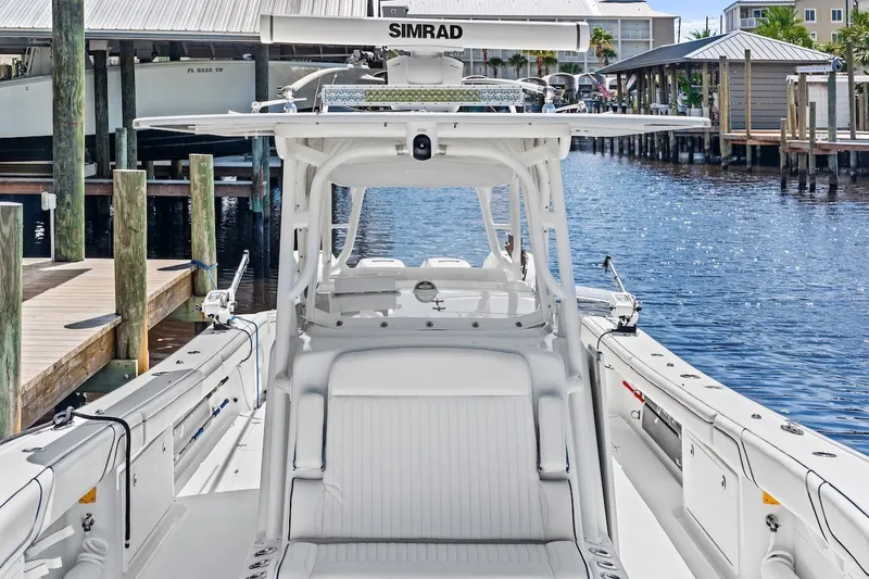 Slide: The Image of 2013 Yellowfin 39 Offshore boat docked, featuring Simrad electronics and spacious seating. - 28