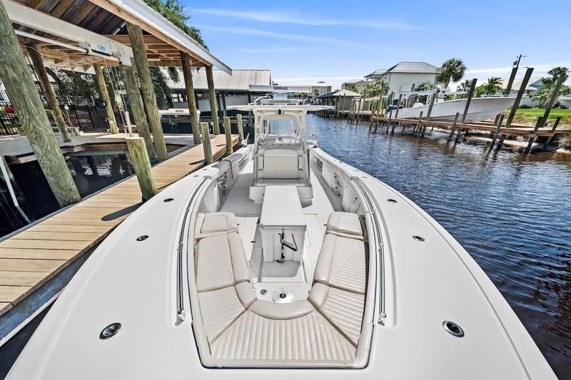 Slide: The Image of 2013 Yellowfin 39 Offshore boat docked, featuring spacious seating and sleek design. - 19