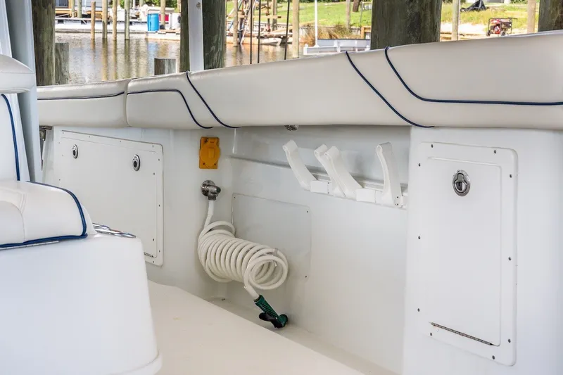 Slide: The Image of Interior view of a 2013 Yellowfin 39 Offshore boat, featuring white seating and storage compartments. - 57