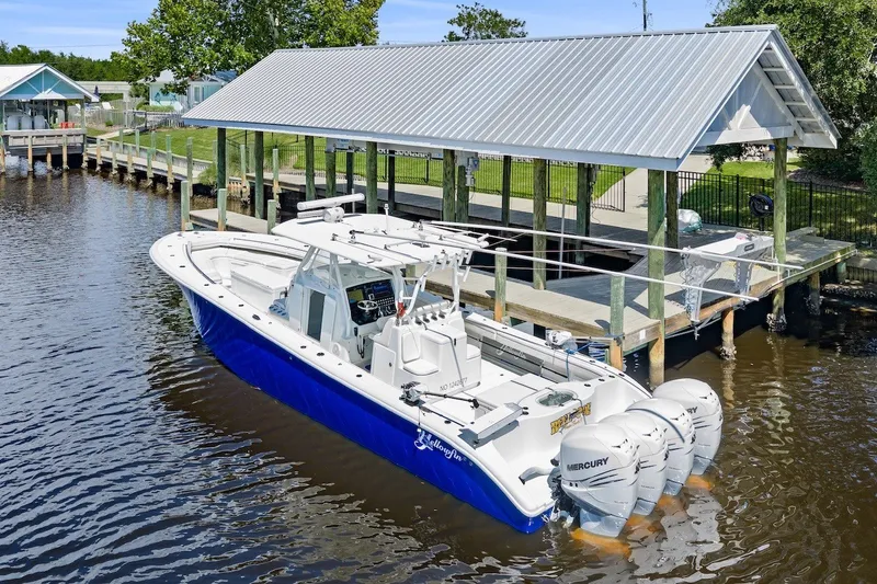 Slide: The Image of 2013 Yellowfin 39 Offshore boat docked with triple Mercury engines. - 8