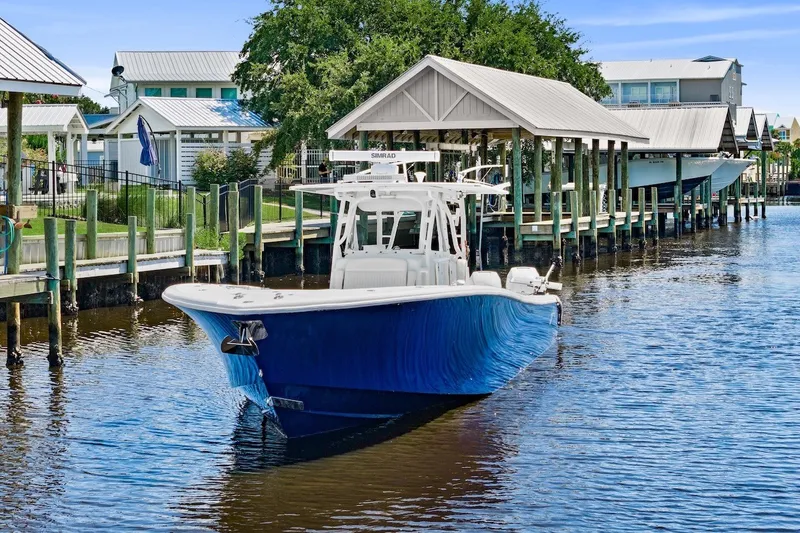Slide: The Image of 2013 Yellowfin 39 Offshore boat docked in a scenic marina setting. - 2