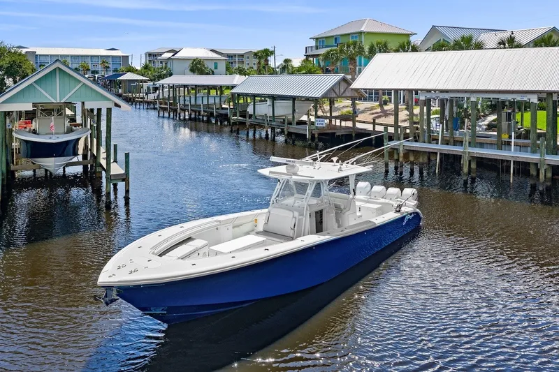 Slide: The Image of 2013 Yellowfin 39 Offshore boat cruising in a scenic marina setting. - 3