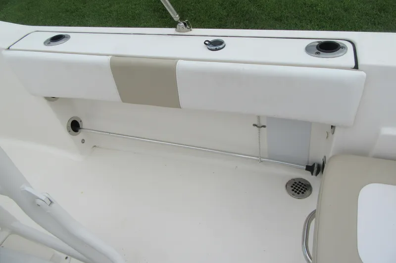 Slide: The Image of 2018 Robalo R180 Center Console boat interior with rod holders and seating. - 20