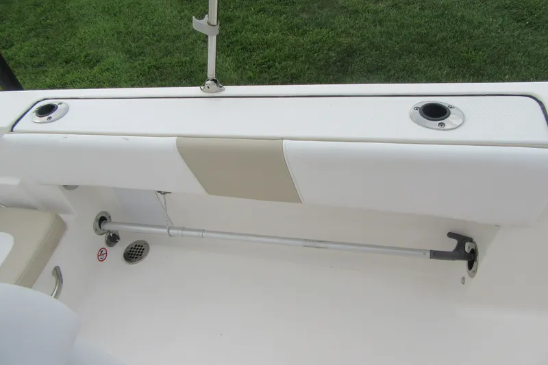 Slide: The Image of 2018 Robalo R180 Center Console boat interior with rod holders and seating. - 19