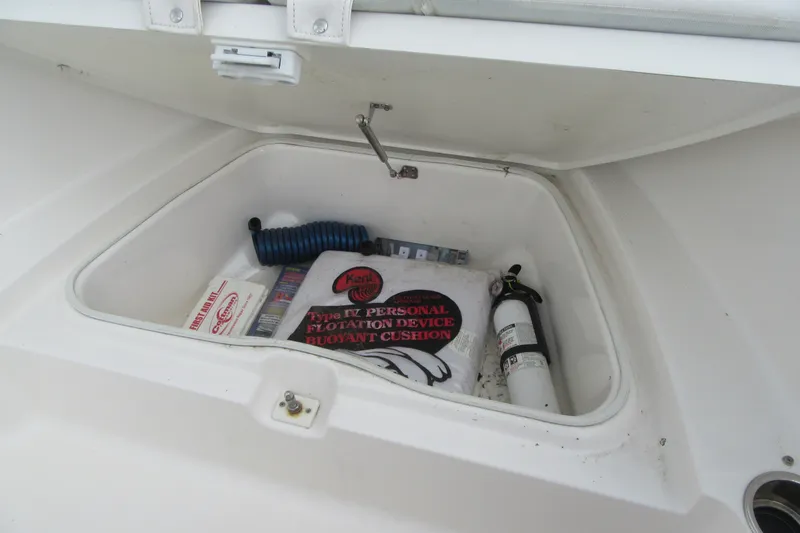 Slide: The Image of Storage compartment of 2018 Robalo R180 Center Console with safety equipment. - 8