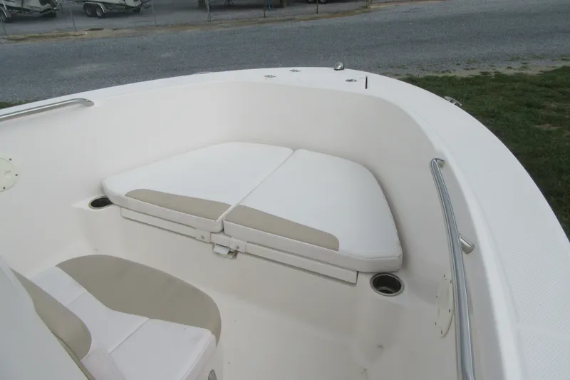 Slide: The Image of 2018 Robalo R180 Center Console boat interior with cushioned seating and cup holders. - 7