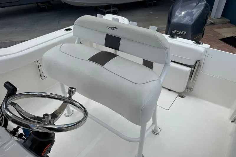 Slide: The Image of Interior of 2013 Tidewater 230 CC Adventure boat with steering wheel and seating. - 14