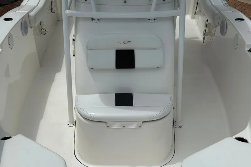 Slide: The Image of 2013 Tidewater 230 CC Adventure boat interior with white seating and console. - 19