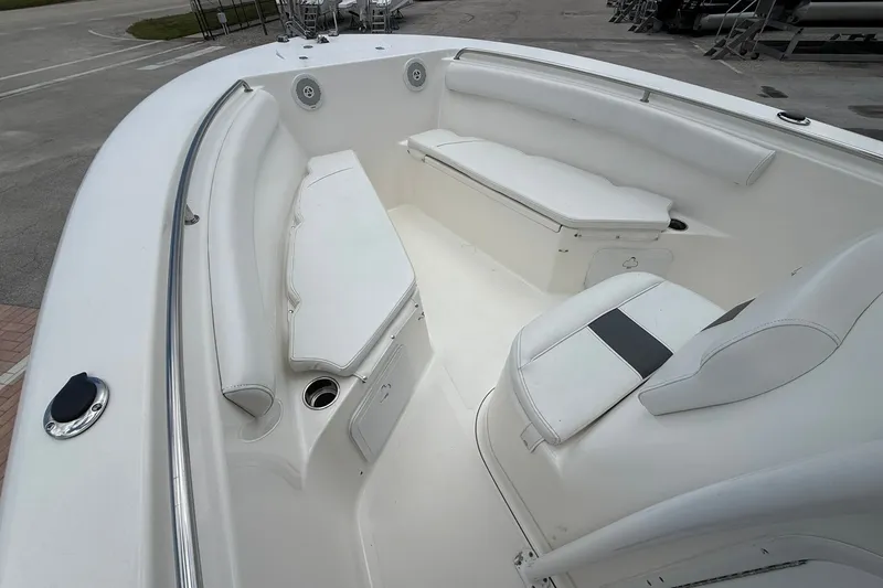 Slide: The Image of 2013 Tidewater 230 CC Adventure boat interior with white seating and stainless steel railings. - 16